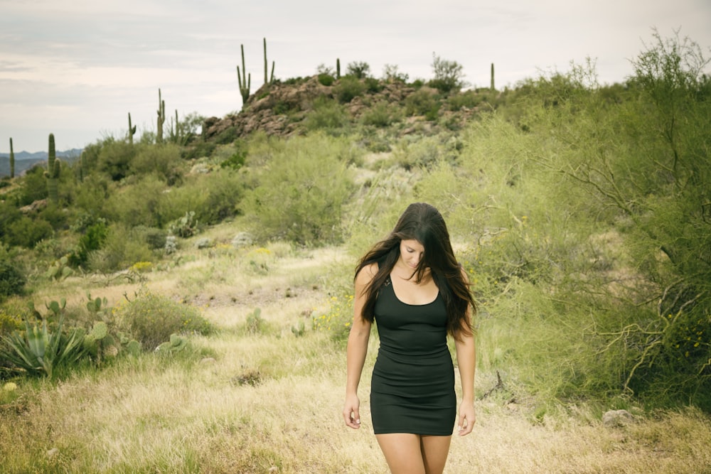 woman wearing black sheath dress