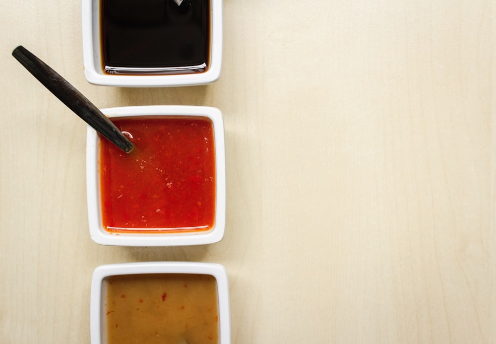 red liquid dip in square bowl