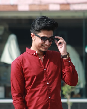 Casual outdoor shot of a person in a red polo shirt enjoying a sunny day.