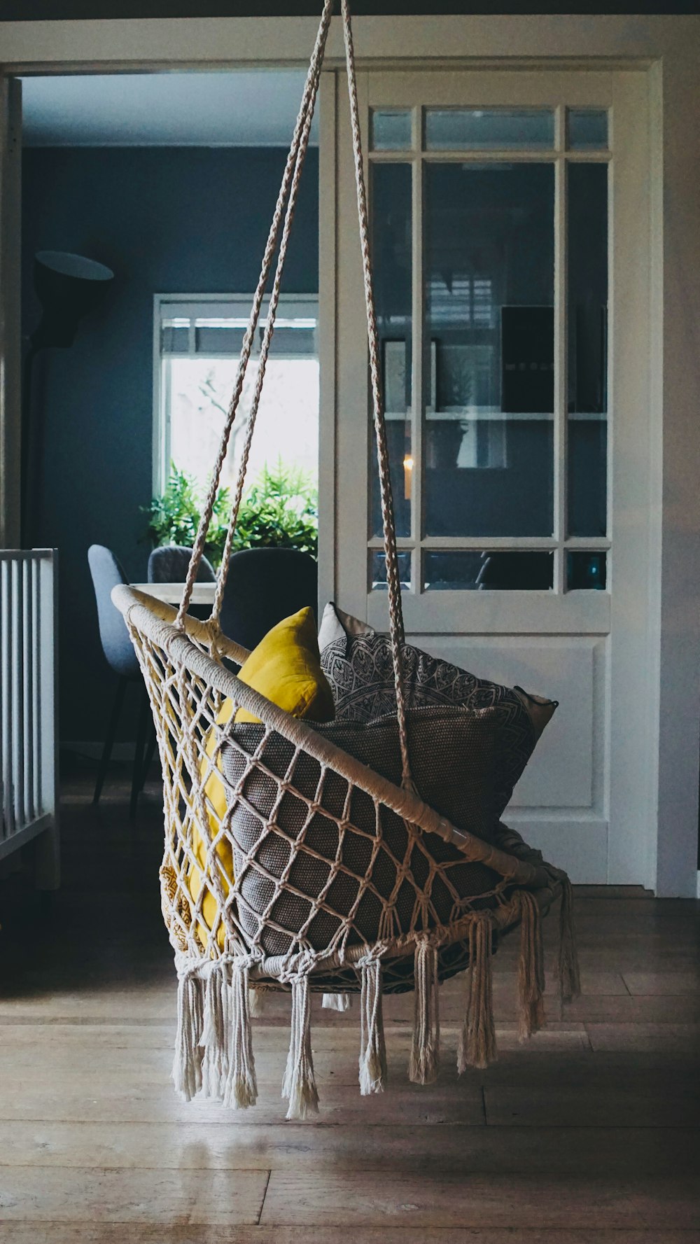 a hammock hanging from a ceiling in a living room