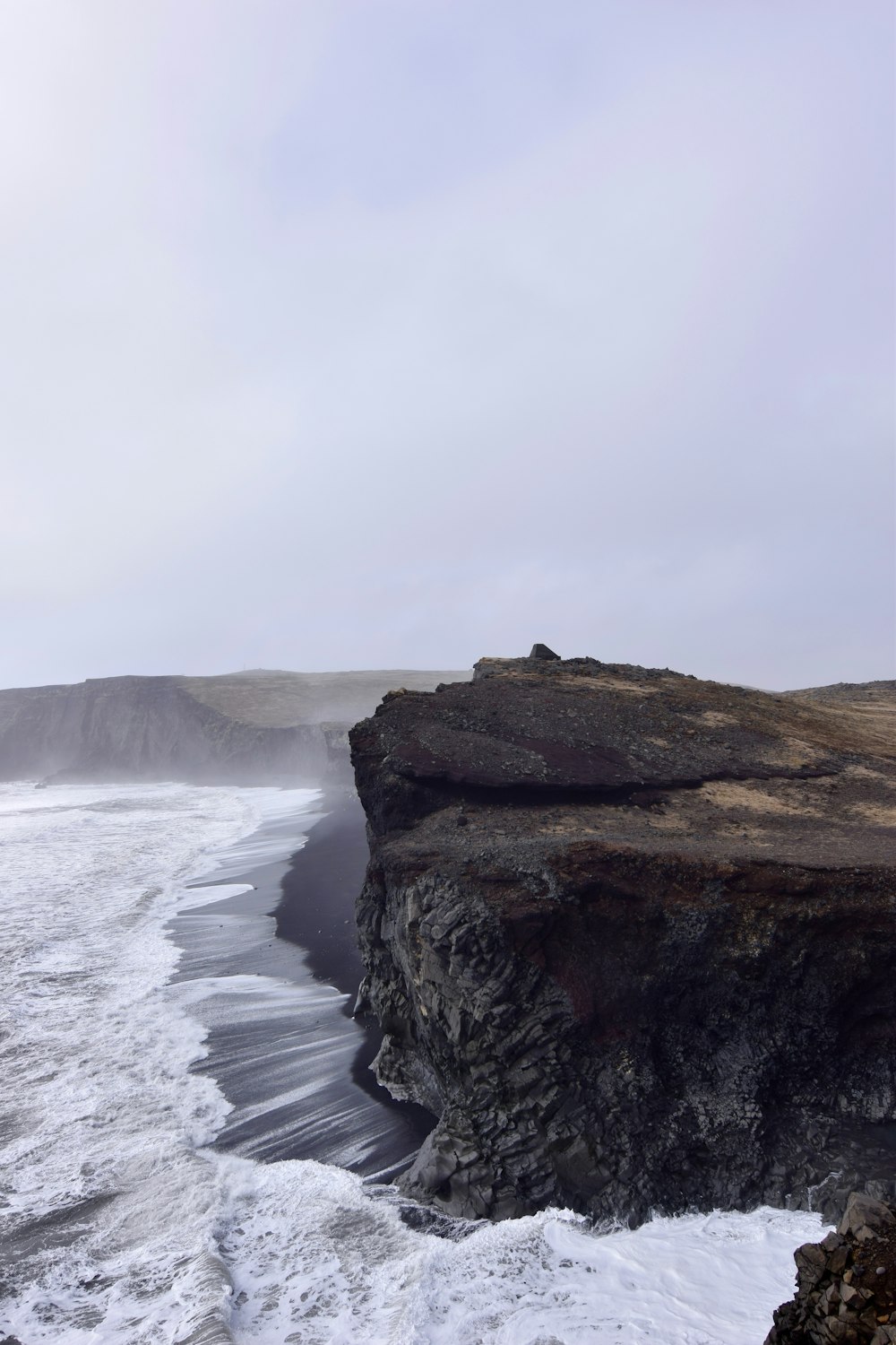 sea wave splashing on cliff