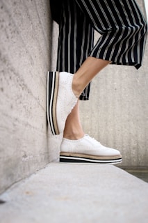 person wearing white sneakers