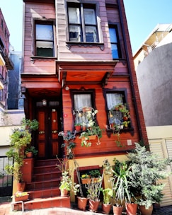 Elegant townhouse with a small terrace and plants.