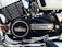 A close-up image of a motorcycle engine featuring the Yamaha branding prominently displayed on the engine casing. The engine has a combination of black and chrome elements, with visible components such as fins, bolts, and a foot peg. The overall appearance is clean and well-maintained, highlighting details of the engine's structure.