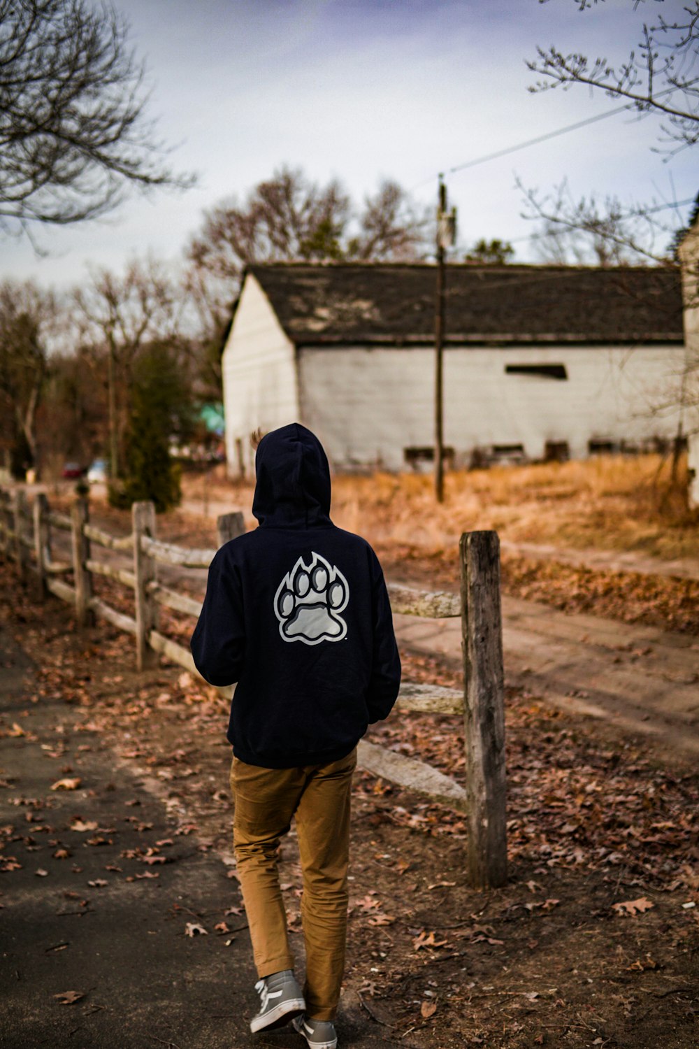 person in black hoodie and brown pants