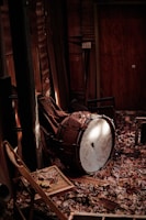 An ancient drum resting on a tapestry of rich, earthy colors with soft glowing light.