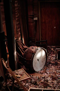 A pair of drums resting against a rustic wall, inviting you to play.