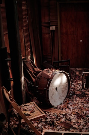 An ancient drum resting on a tapestry of rich, earthy colors with soft glowing light.