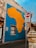 A large mural of Africa painted on a building wall with bright yellow and blue colors. Nearby, there is a 'No Entry' road sign and a 'One Way' sign attached to the wall. The surrounding area has urban elements such as a street lamp and textured walls.