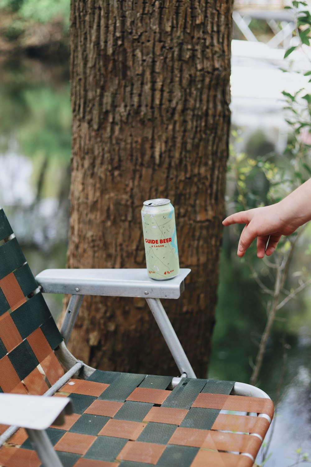 gray and red can on chair's arm