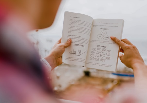 person reading book during daytime