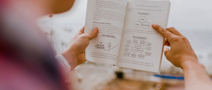 person reading book during daytime