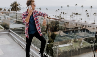 unknown person in red plaid shirt talking on phone at terrace