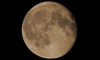 A close view of the detailed surface texture of a 3D printed moon lamp under soft lighting