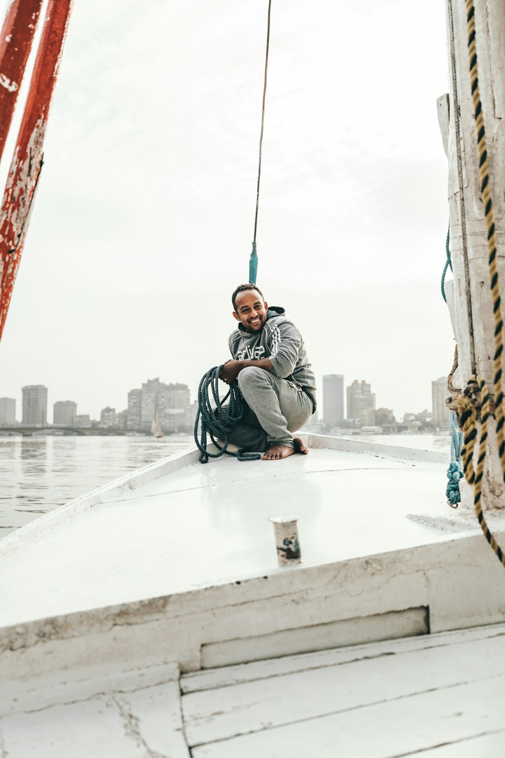 man sitting on boat during daytime