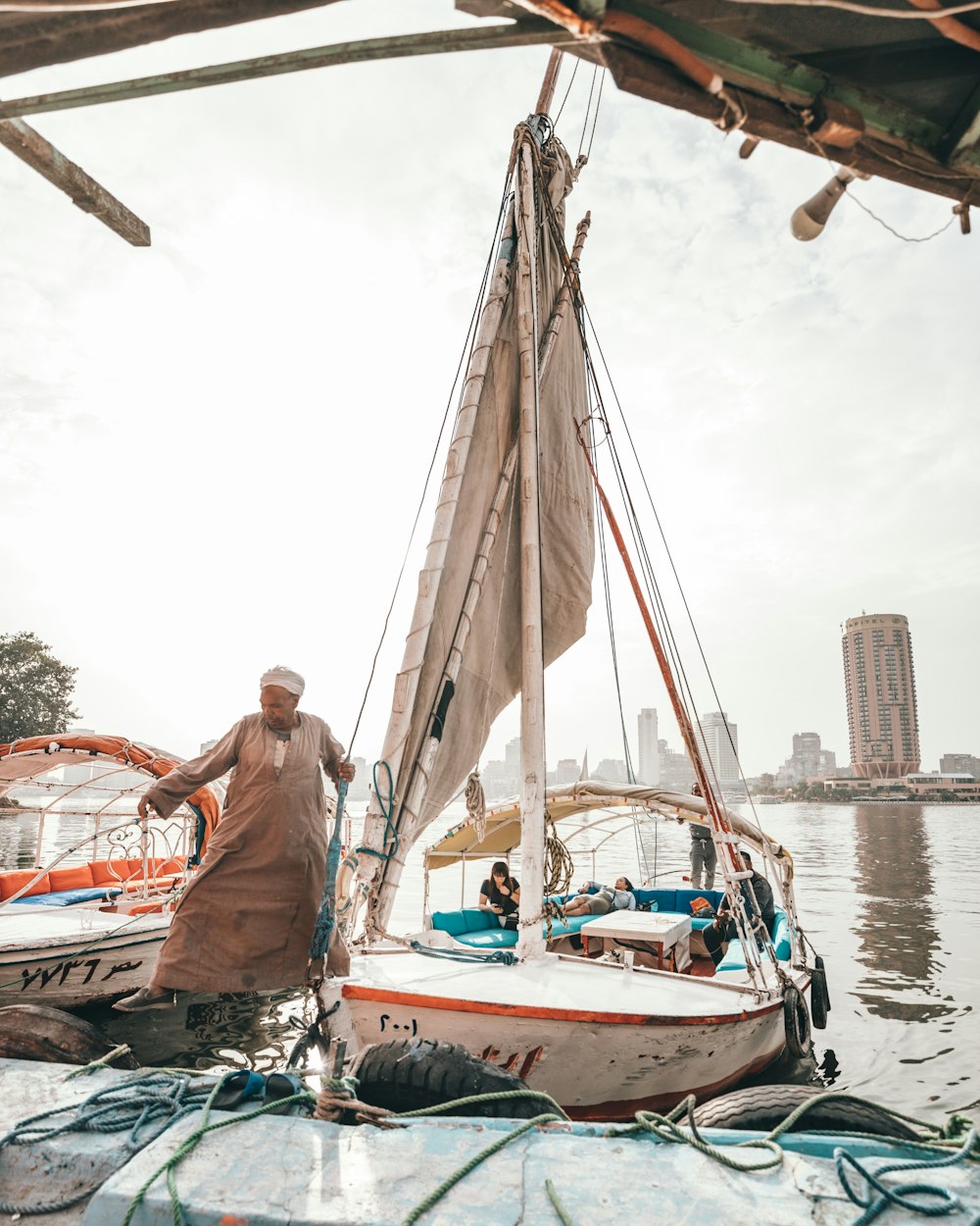 man standing near sailing boat