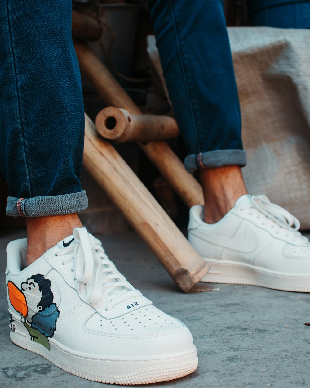 man wearing white low-top sneakers