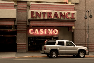 silver SUV parking beside Casino building