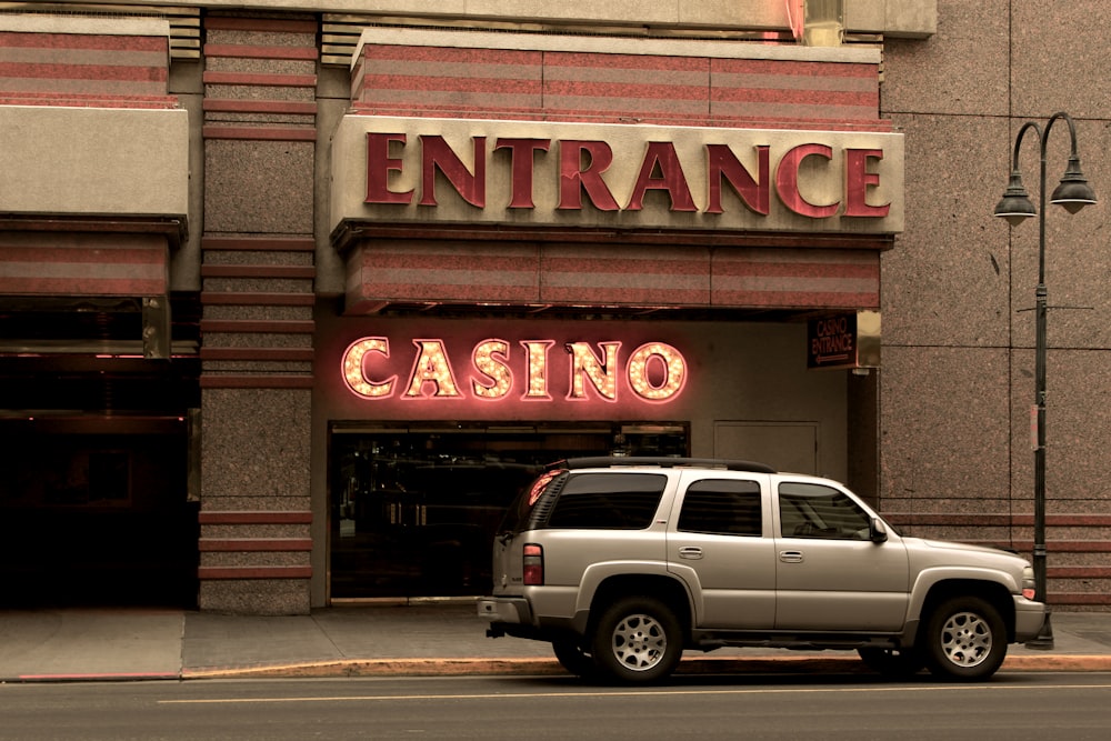 silver SUV parking beside Casino building