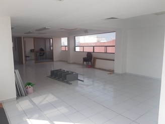 An empty living room being cleaned with equipment.