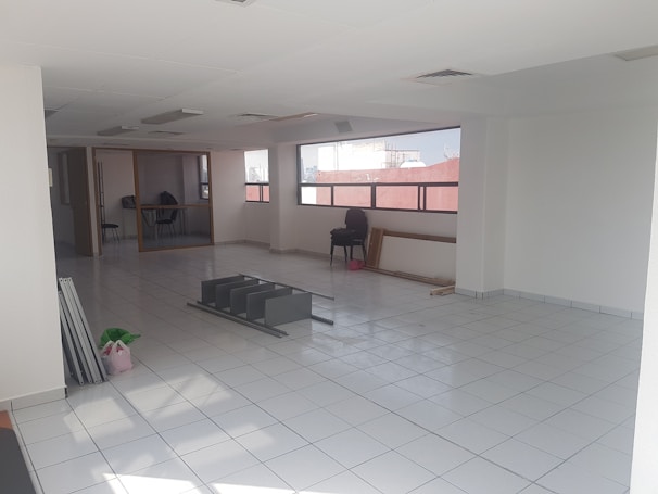 An empty living room being cleaned with equipment.