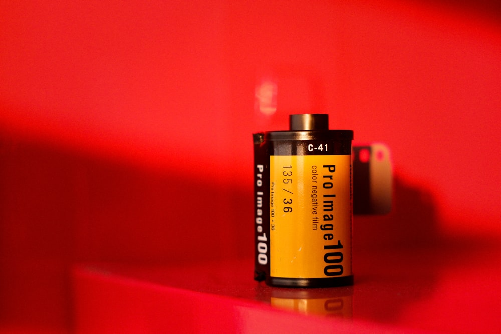 yellow and black battery on red surface