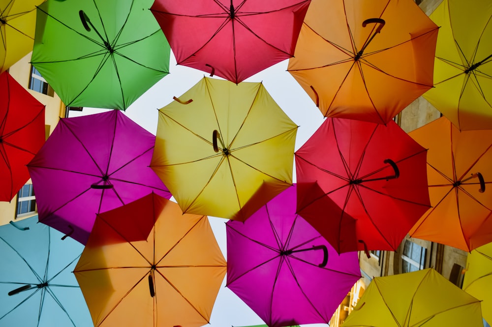 low angle photography of assorted umbrellas during daytime