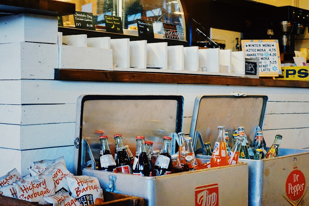 assorted soda bottle in white cooler boxes