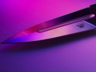 A vibrant blue and purple backdrop highlighting a set of knives ready for sale