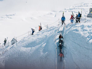 A small group of skiers attentively participating in a mountain safety training session.
