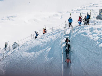 A group of skiers attentively participating in a winter safety training session on a snowy mountain.