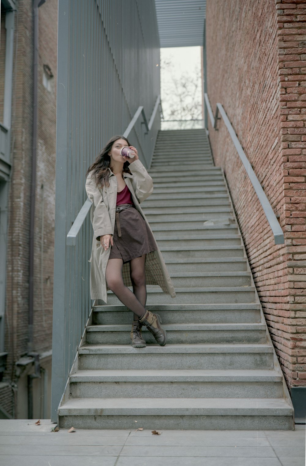 woman standing on gray stair