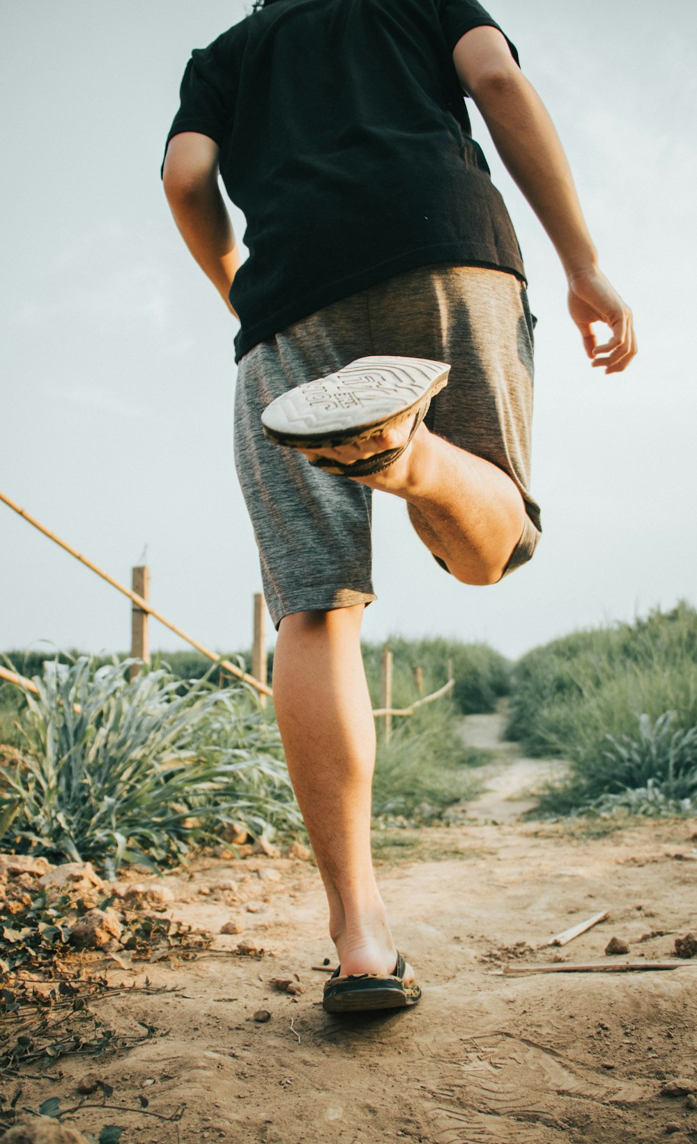 person running on dirt road