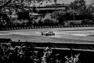 A dynamic shot of a Formula 1 car speeding around a sharp corner on the track.