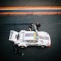 classic white Porsche 911 at pit stop with crew