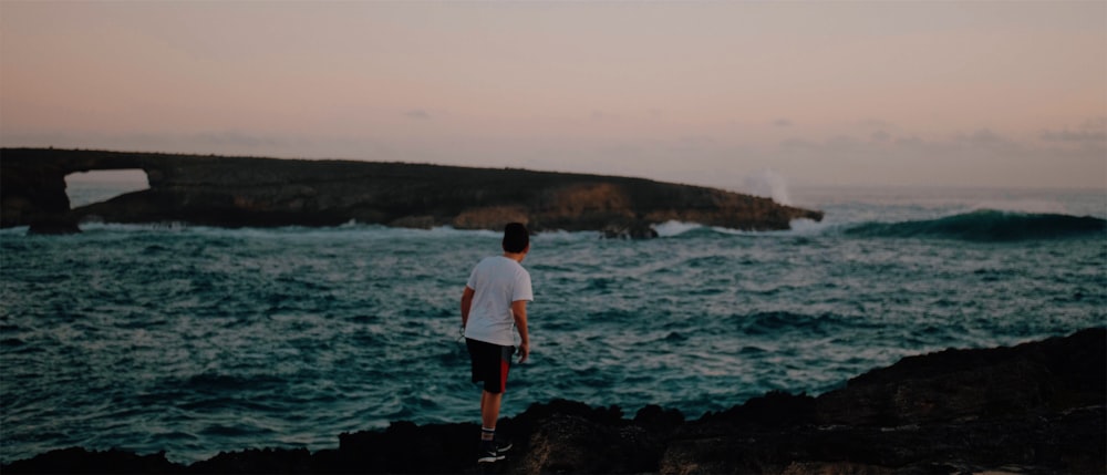 man standing near body of water during daytime