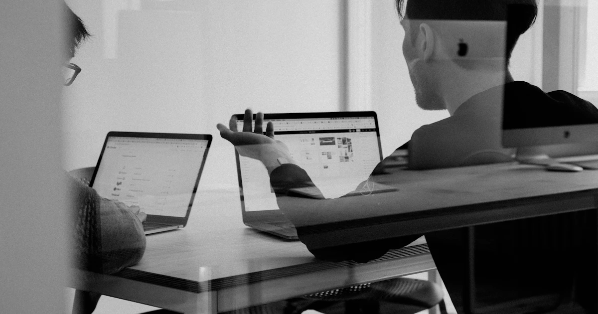 Cloud infrastructure team collaborating around multiple monitors displaying network graphs and server metrics