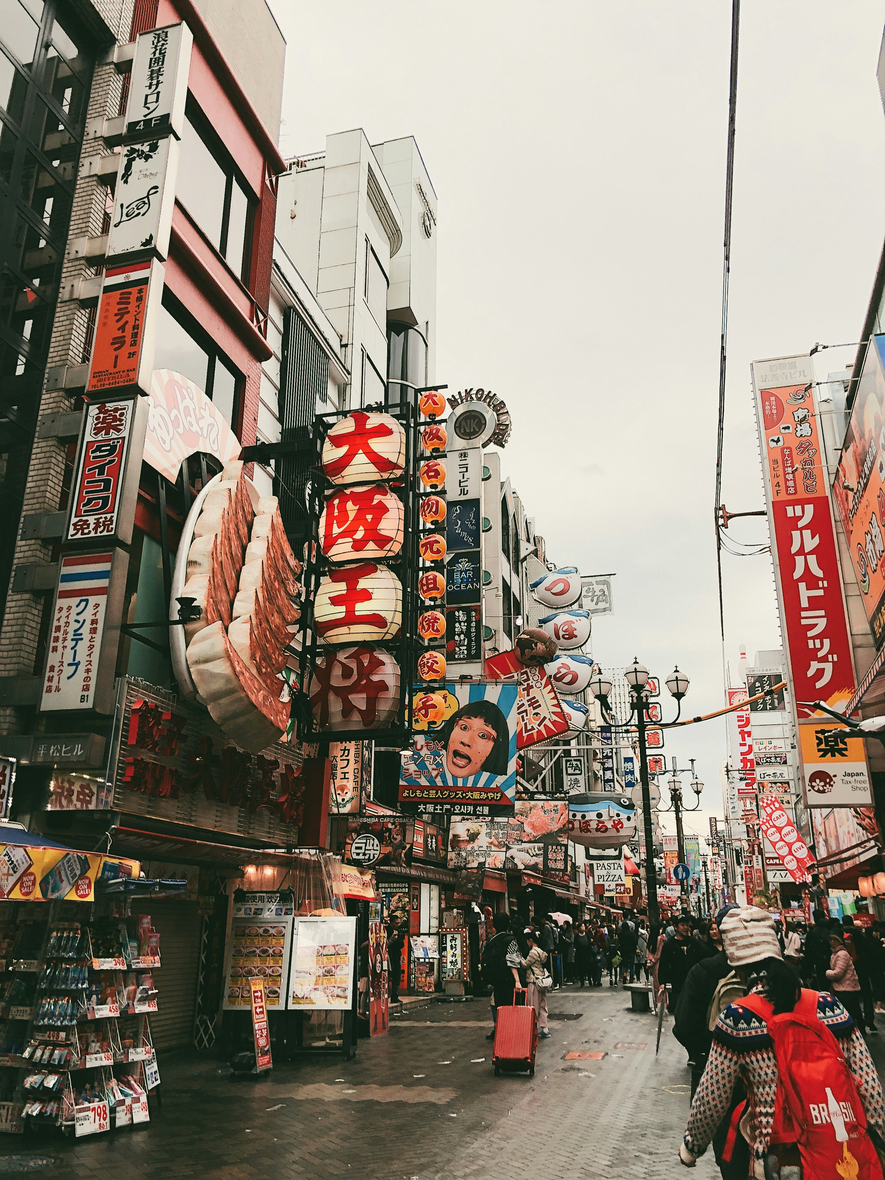 Busy Japanese street market with colorful food stalls