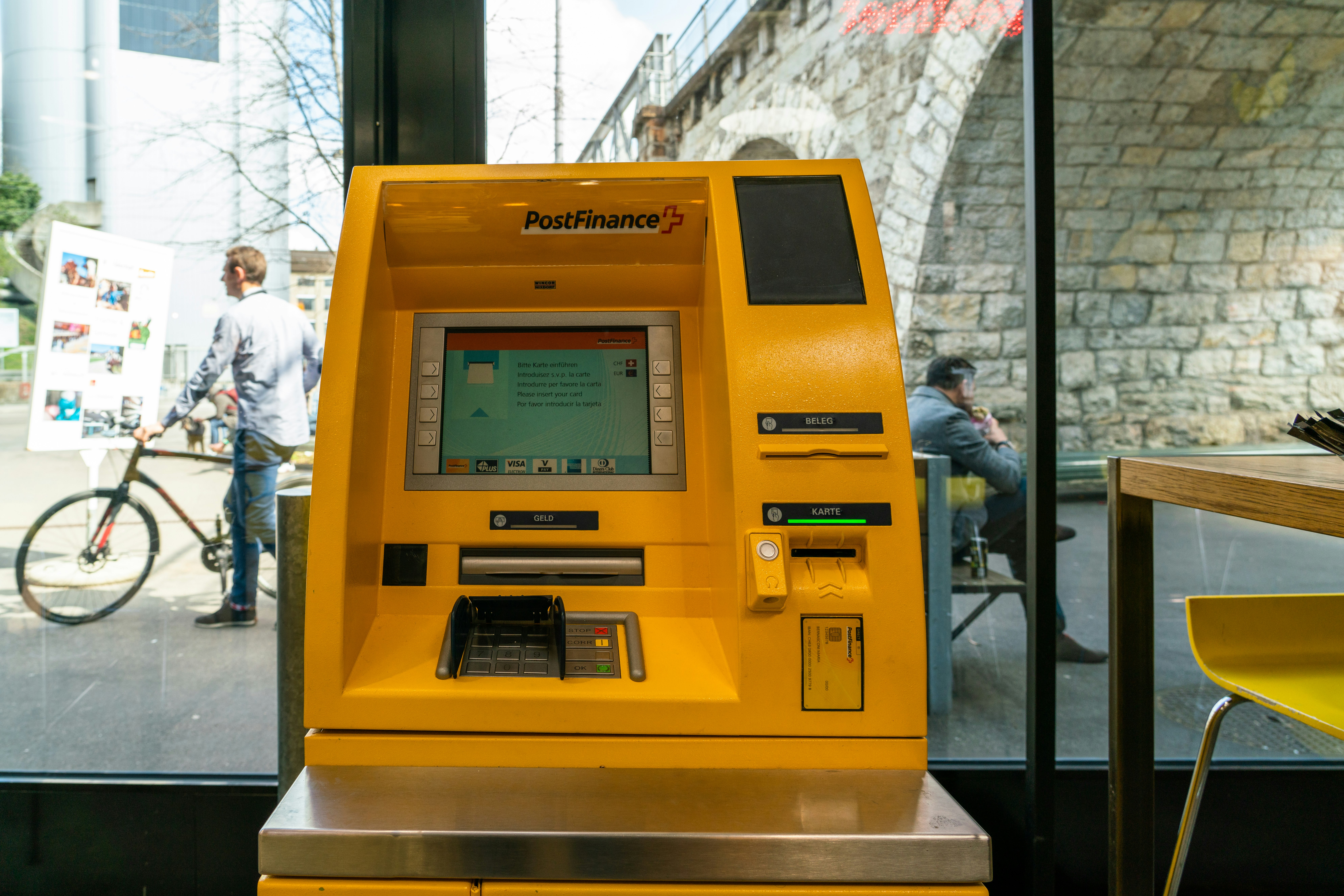 Post Finance ATM machine near glass wall