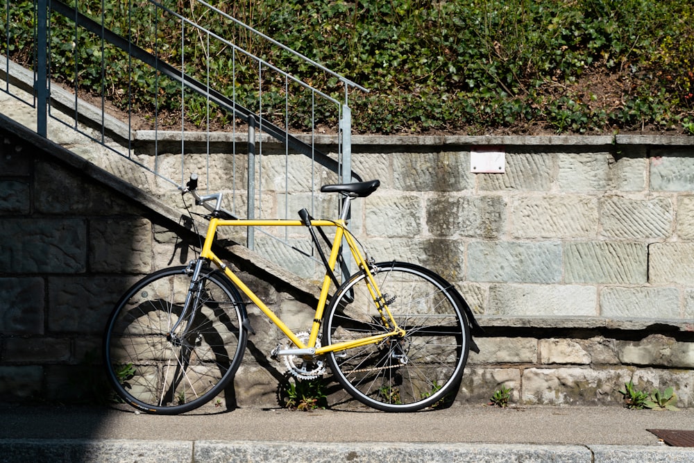 yellow mountain bike leaning on stair