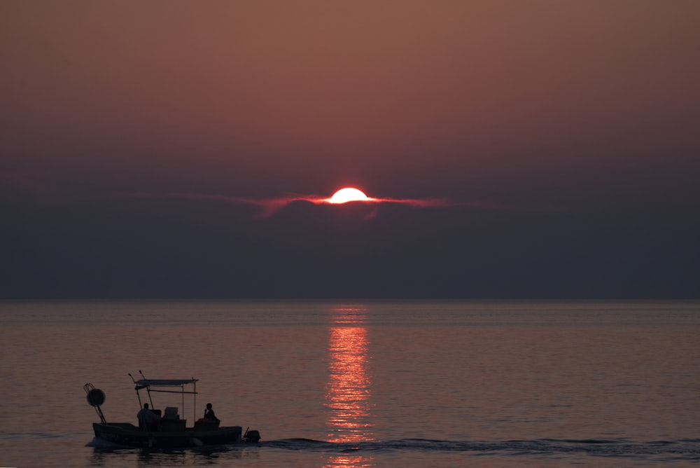 silhouette of boat on body of water