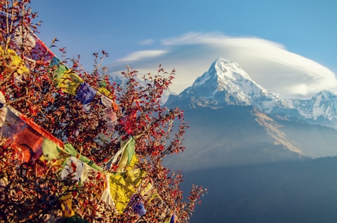 mountain covered with snow under cloudy sky
