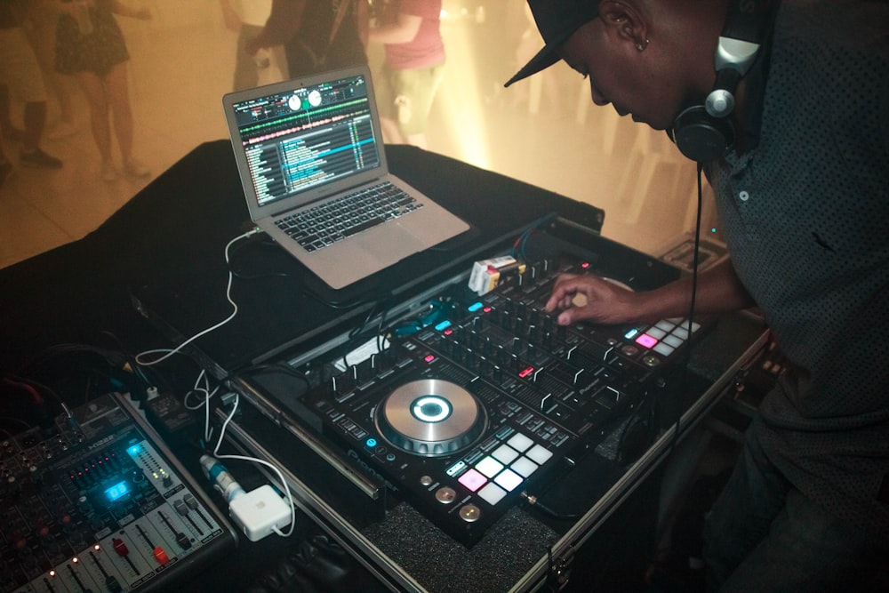 man wearing black shirt in front of DJ mixer