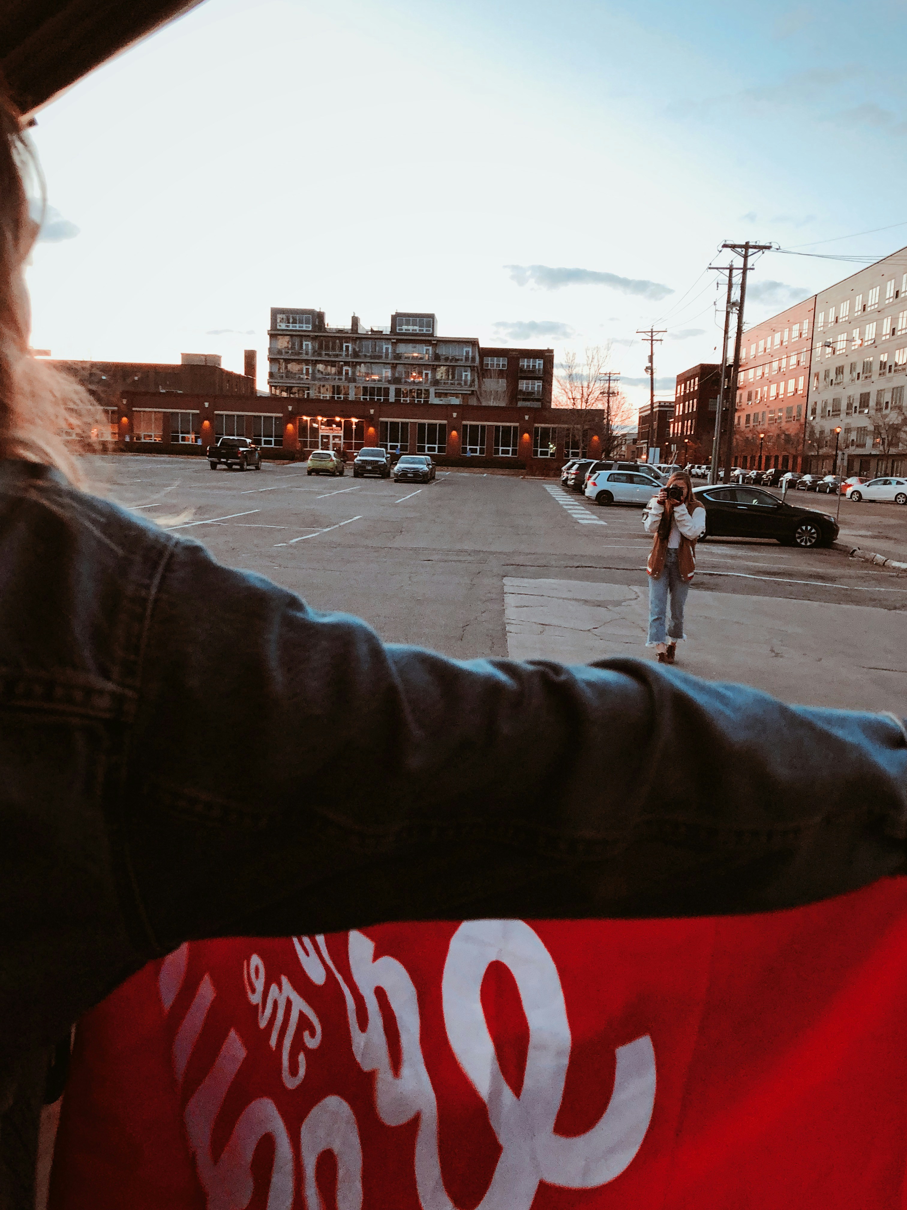 a person riding a skateboard in a parking lot