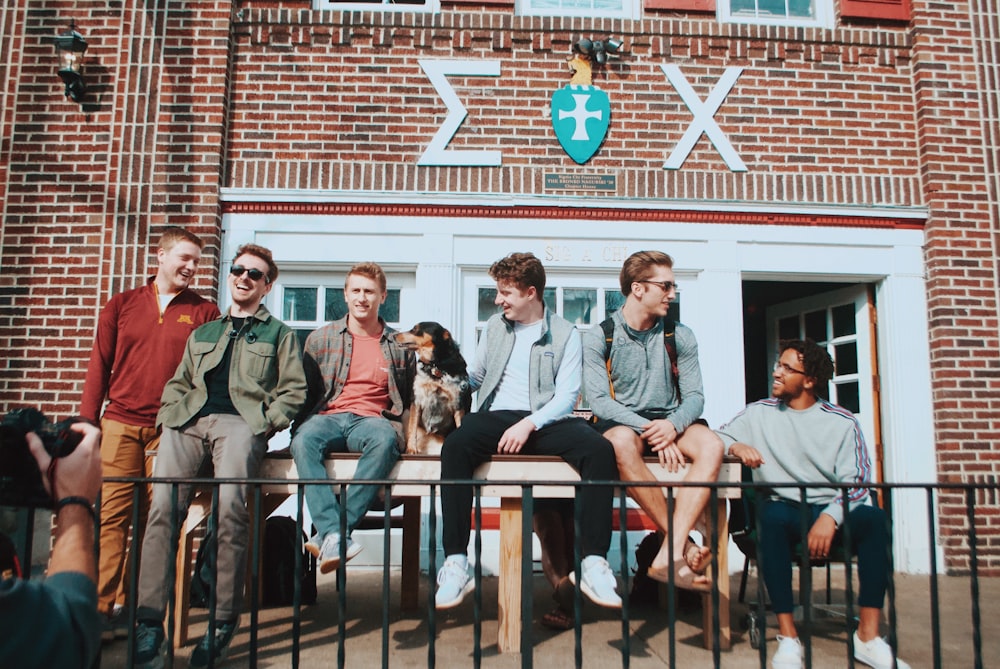 photo of people sitting on table beside store