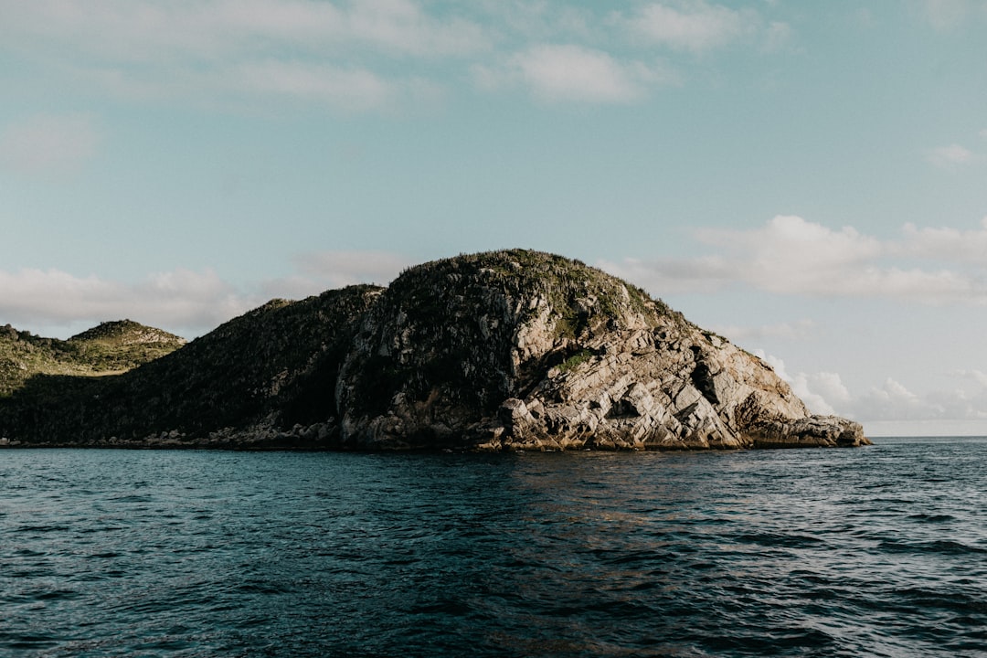 mountain surrounded by body of water