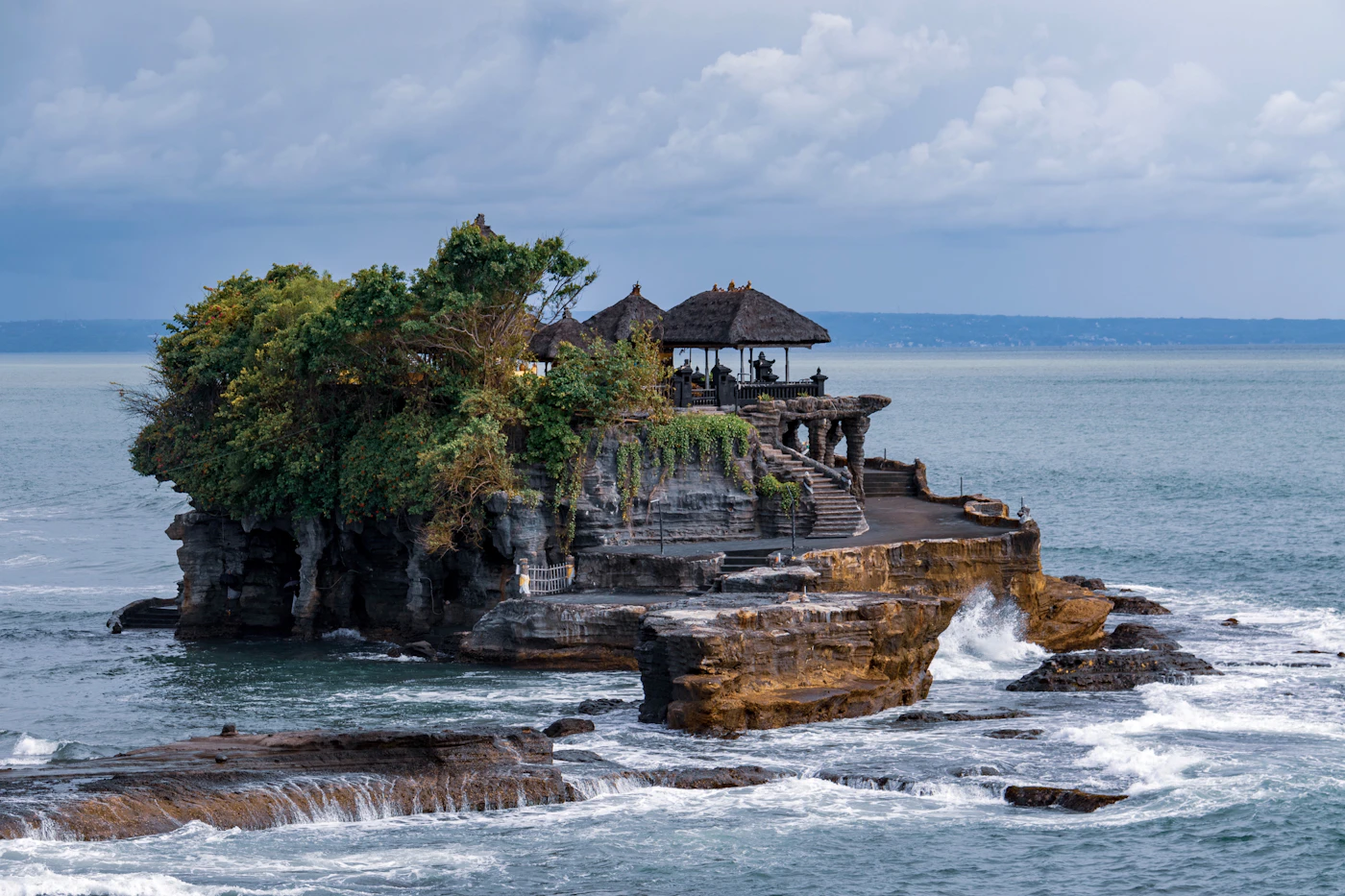 A structure standing securely on a rock formation beside the sea, illustrating the importance of a strong foundation