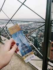 A close-up of a ticket with a cityscape background.