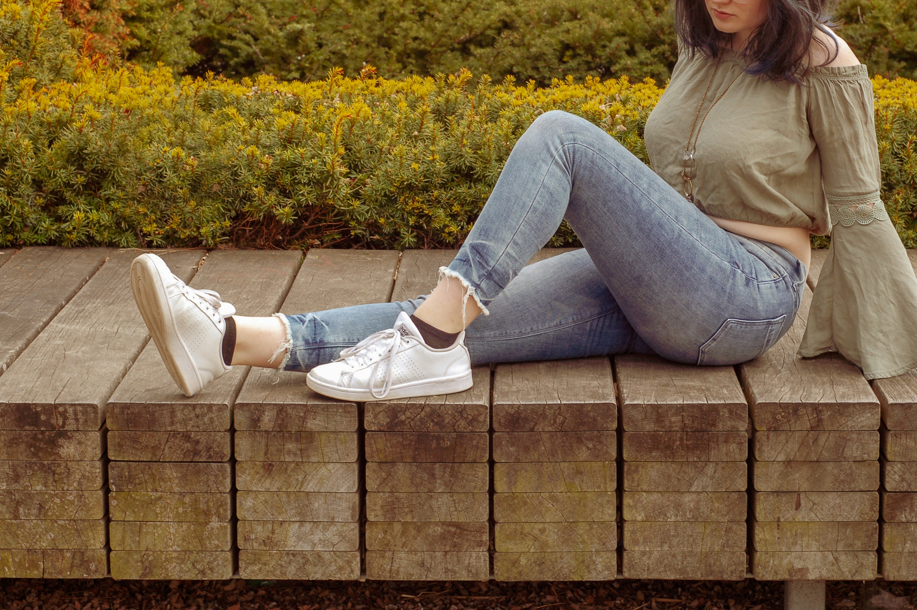 woman sitting on brick bench