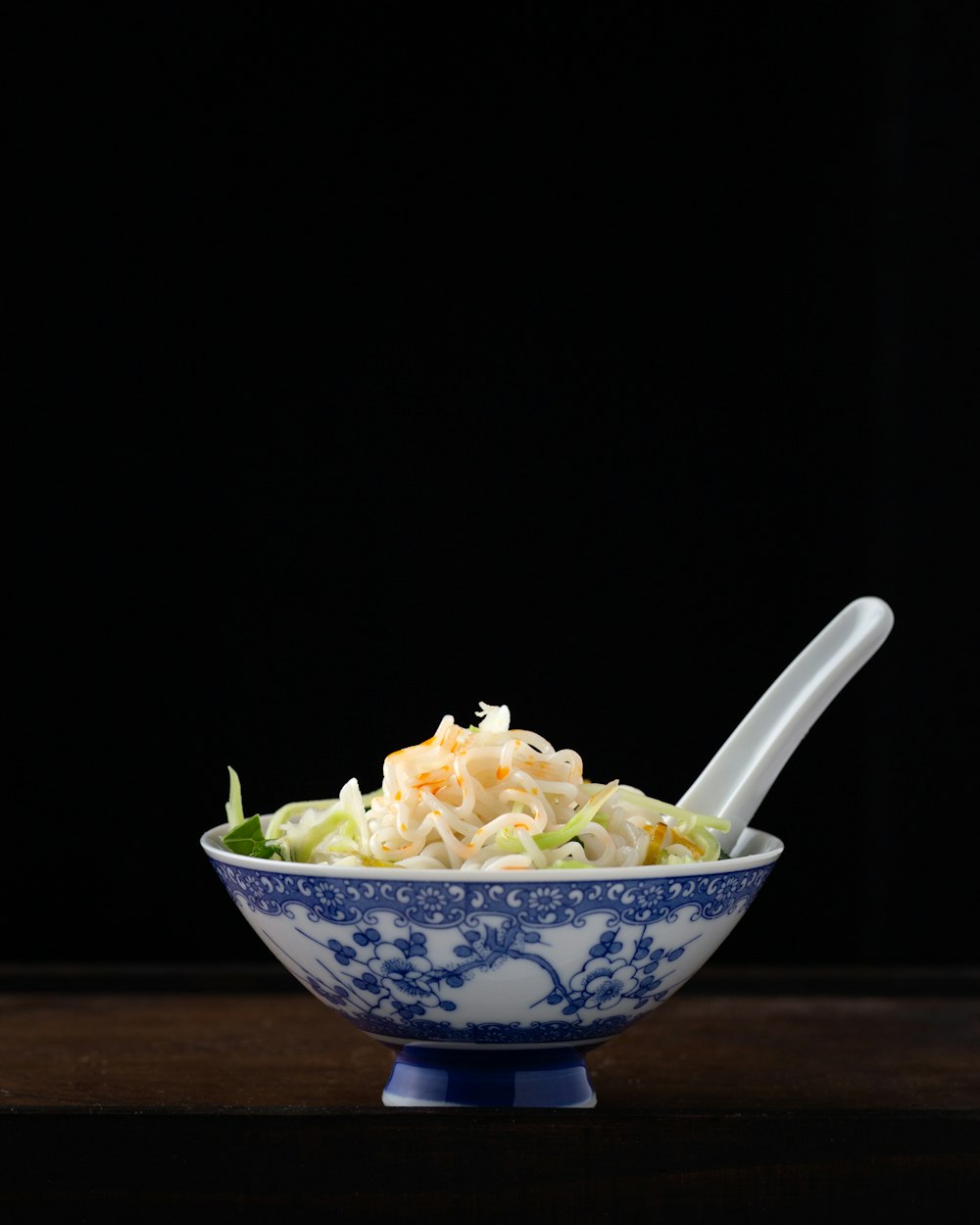 noodles in white and blur floral bowl